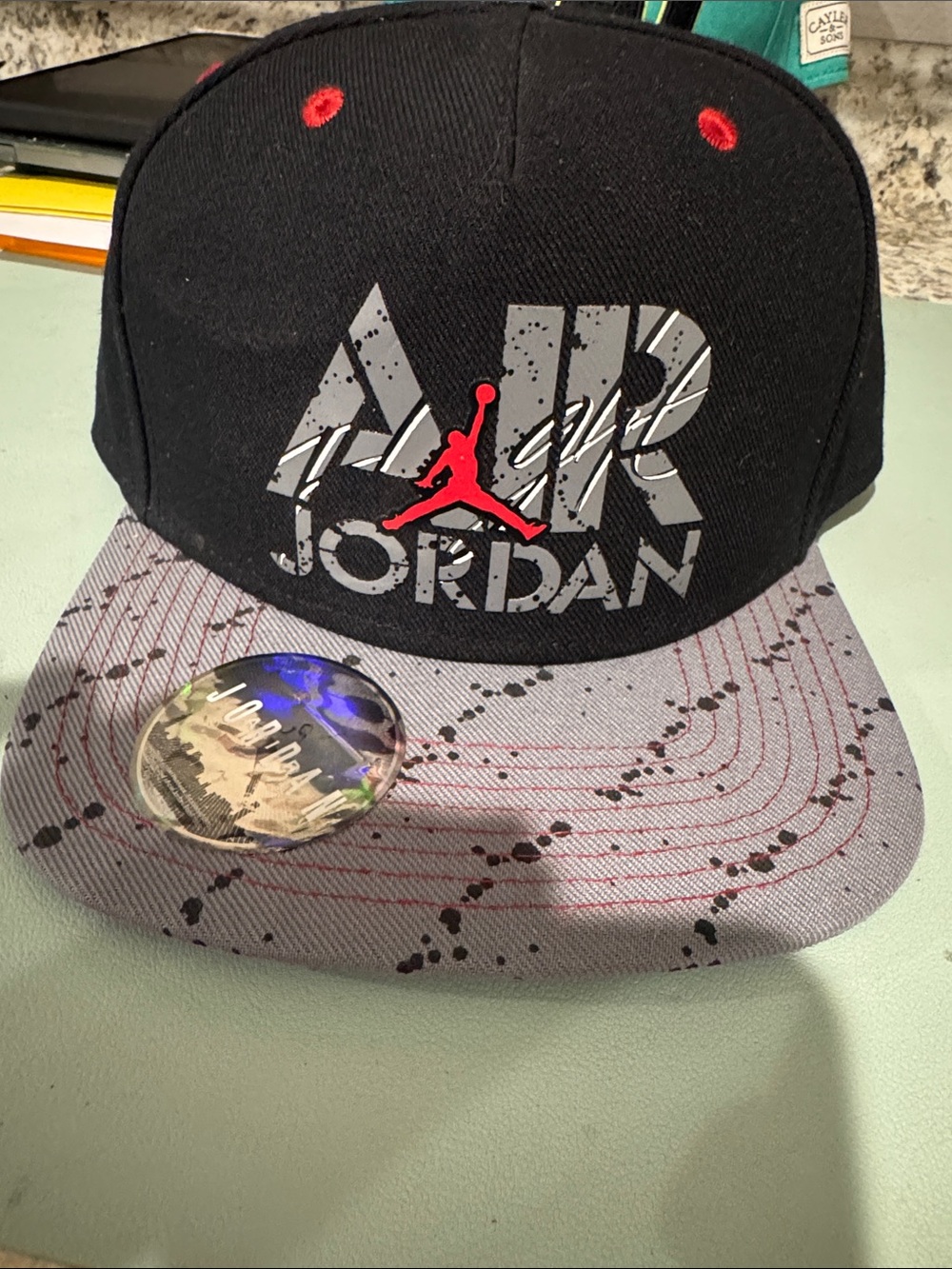 Jordan Black Snapback Hat with Gray Brim and Red Accent